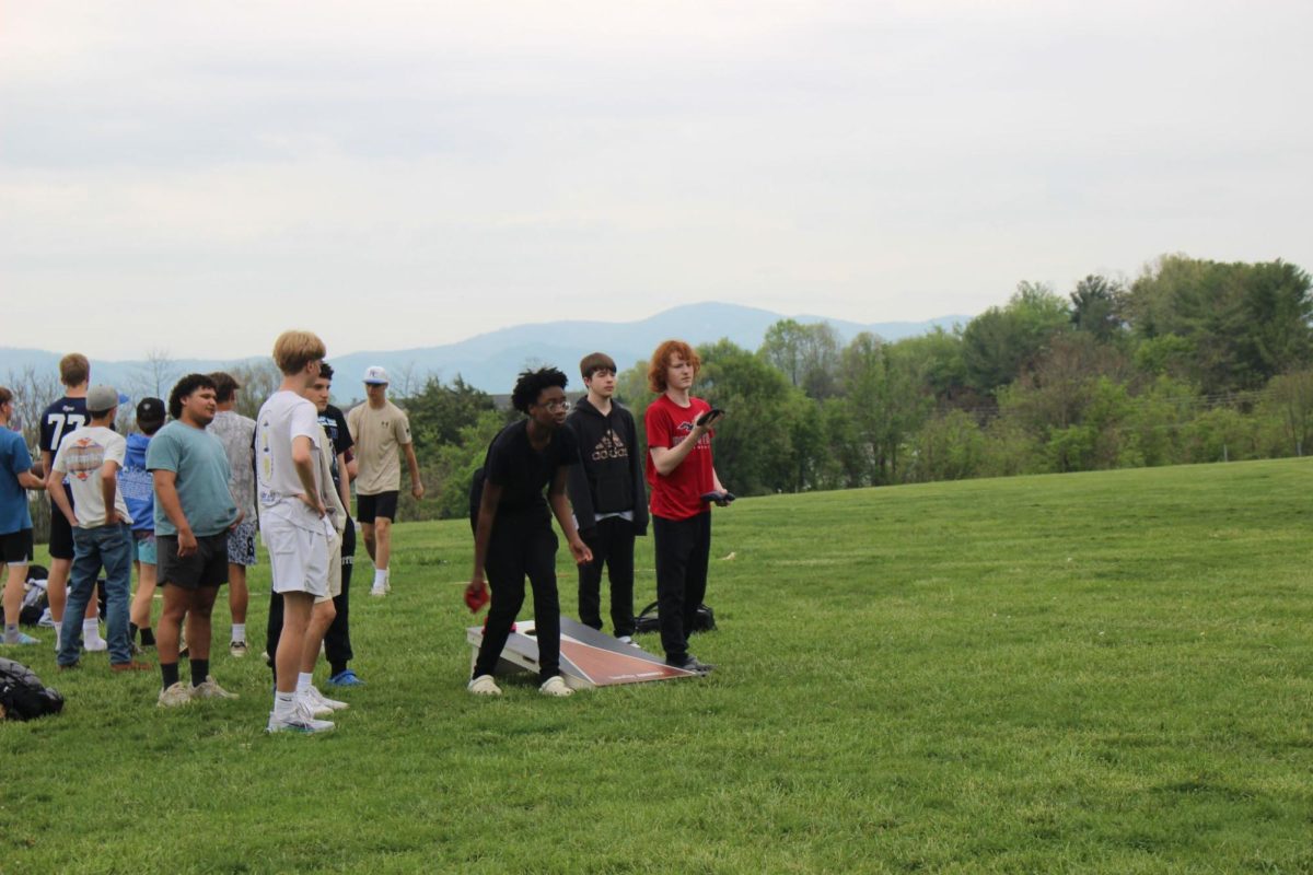 Students play cornhole during the event.