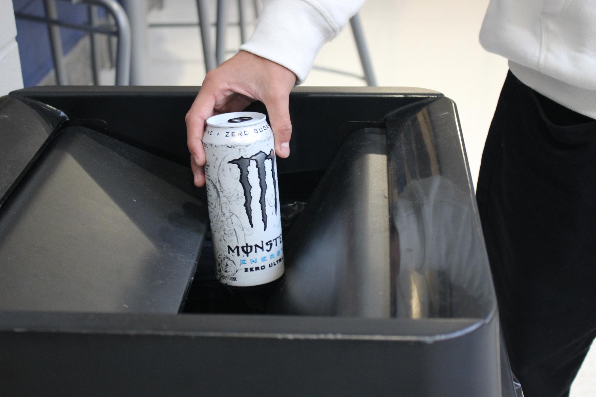 Student Jonathan Soriano throwing away a Monster Energy drink.