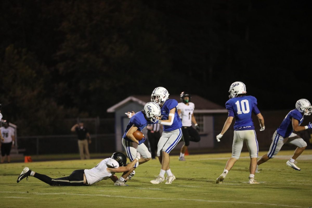 Senior Trevor Hoke tries to escape a tackle from his opponent.