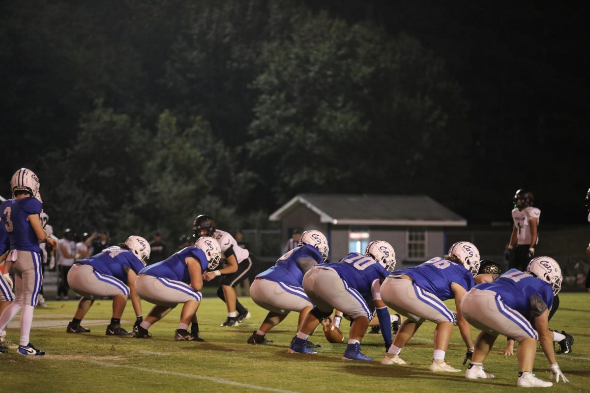 The O-line prepares to snap the ball. 