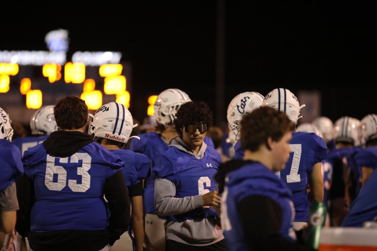 Injured Senior Cole Dorey passes out sour patch kids to his teammates. 