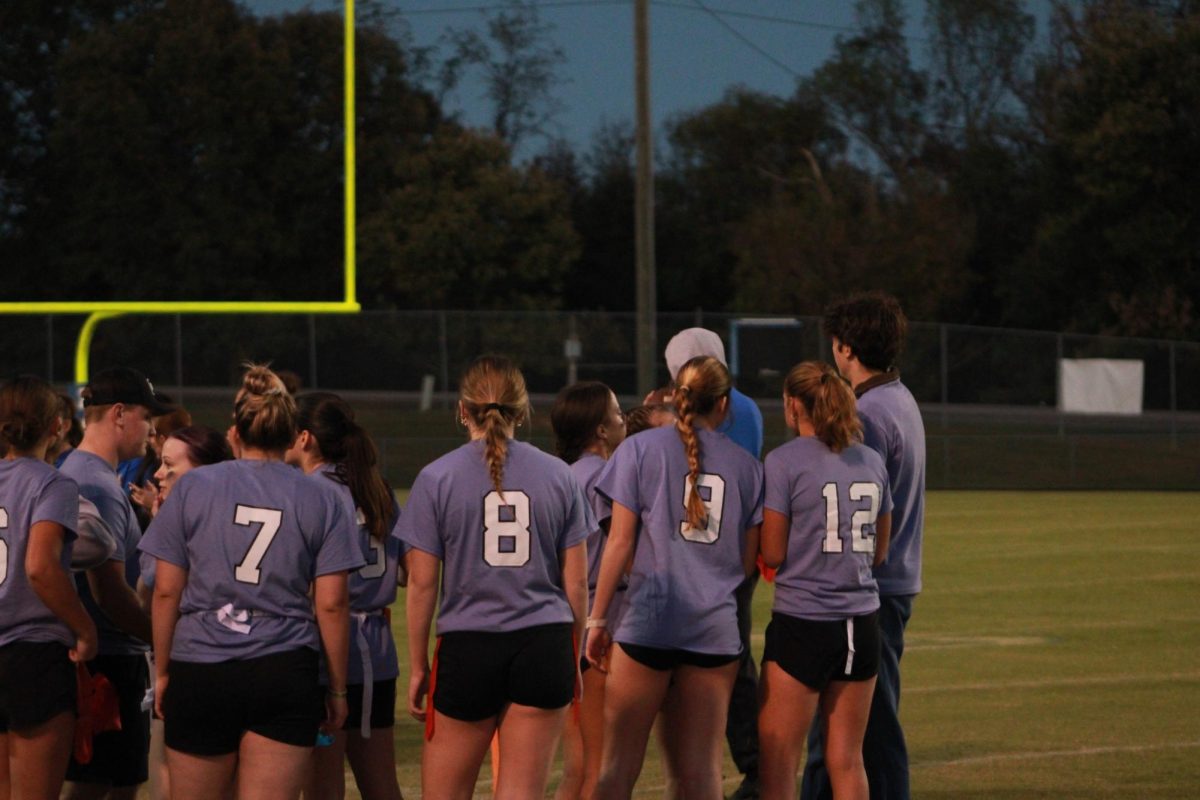 The Junior team huddles together.