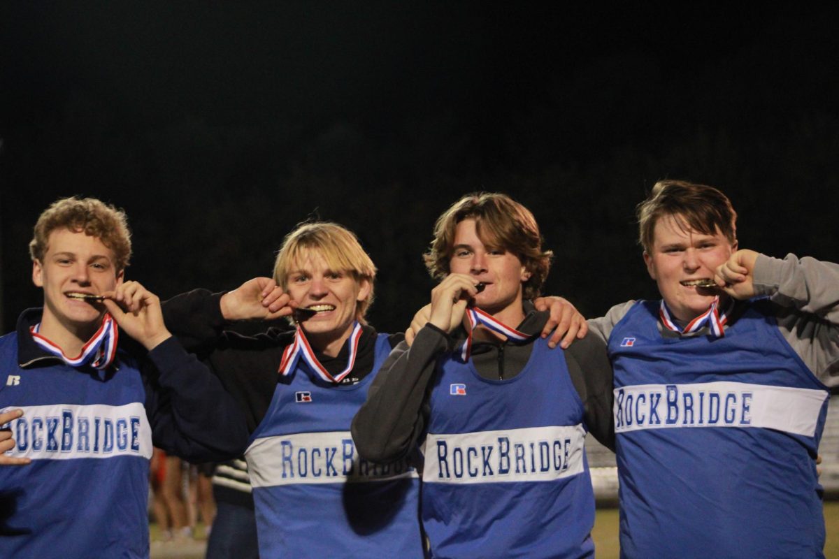 Cheerleaders show off their medals.