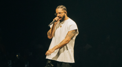 Drake singing at a concert 