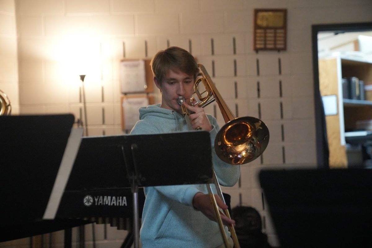 Clark practices his trombone in band class.