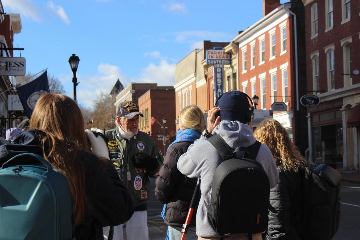 Journalism students getting interviews from a veteran 