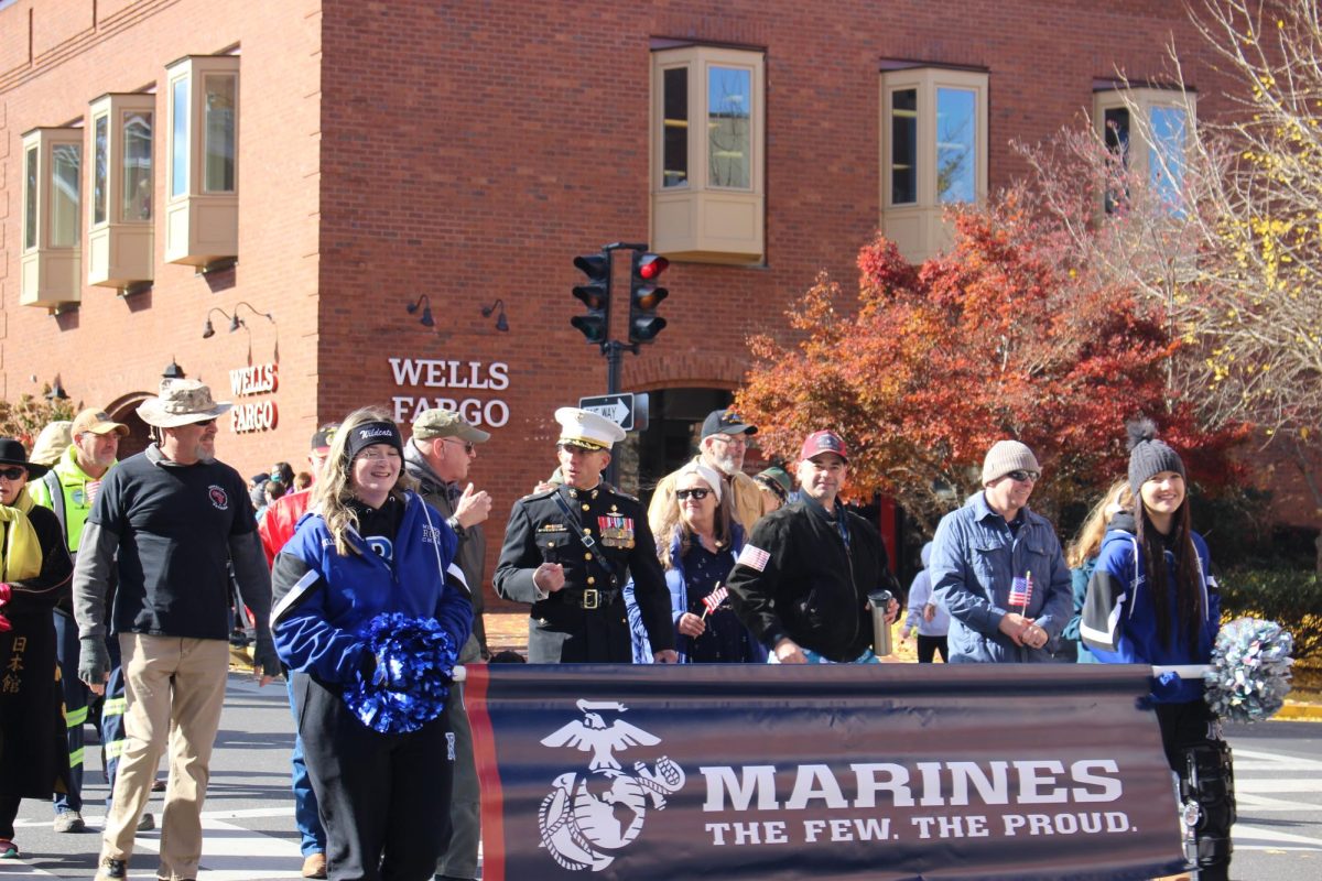 The veterans from the Marines walk behind. 