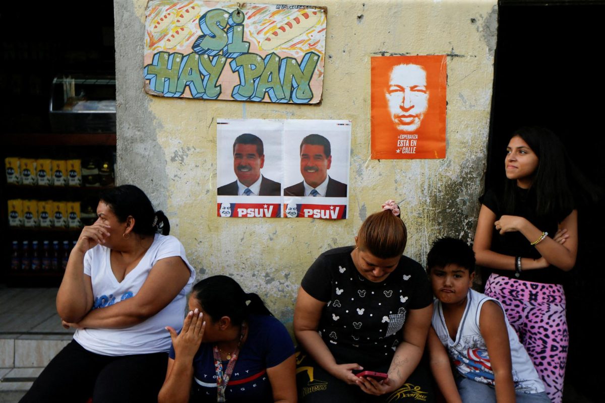 People sit in front of posters for the reelection campaign of President Nicolas Maduro during a rally of the United Socialist Party of Venezuela (PSUV) in support of Maduro, in Caracas, Venezuela June 20, 2024. REUTERS/Leonardo Fernandez Viloria