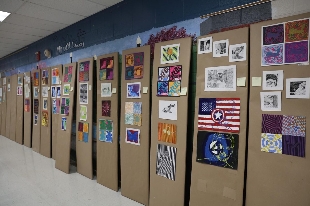 Artwork for the Commons Art Showcase leans outside of art teacher Erin Allen’s classroom.