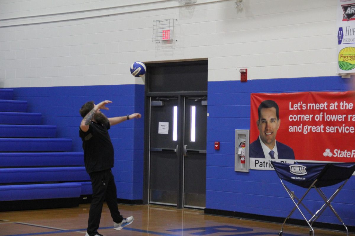 Teacher Mr. Rhodinezer prepares for the game.