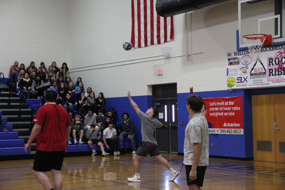 Senior Aiden Meyers serves the ball.