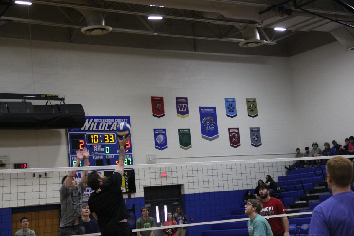 Rhodenizer hits the ball to the other side. 
