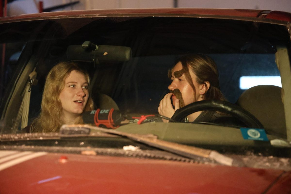 Seniors Presley Brzostek and Summer Hull act out a drive-in scene for the Trivium mini movie.