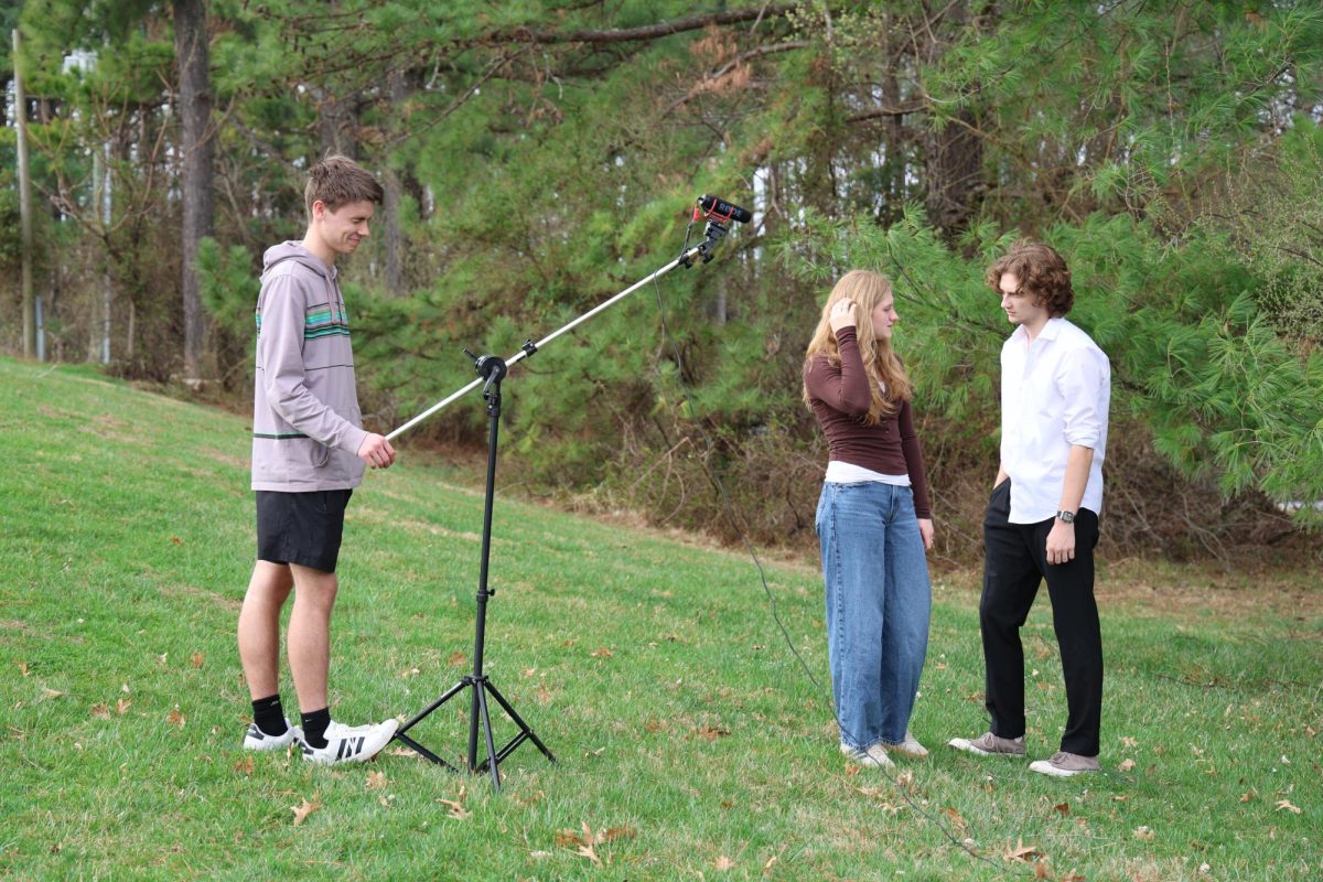 Senior Noah Alexander films senior actors Summer Hull and River Jenkins during a scene in the "Twilight" mini movie.