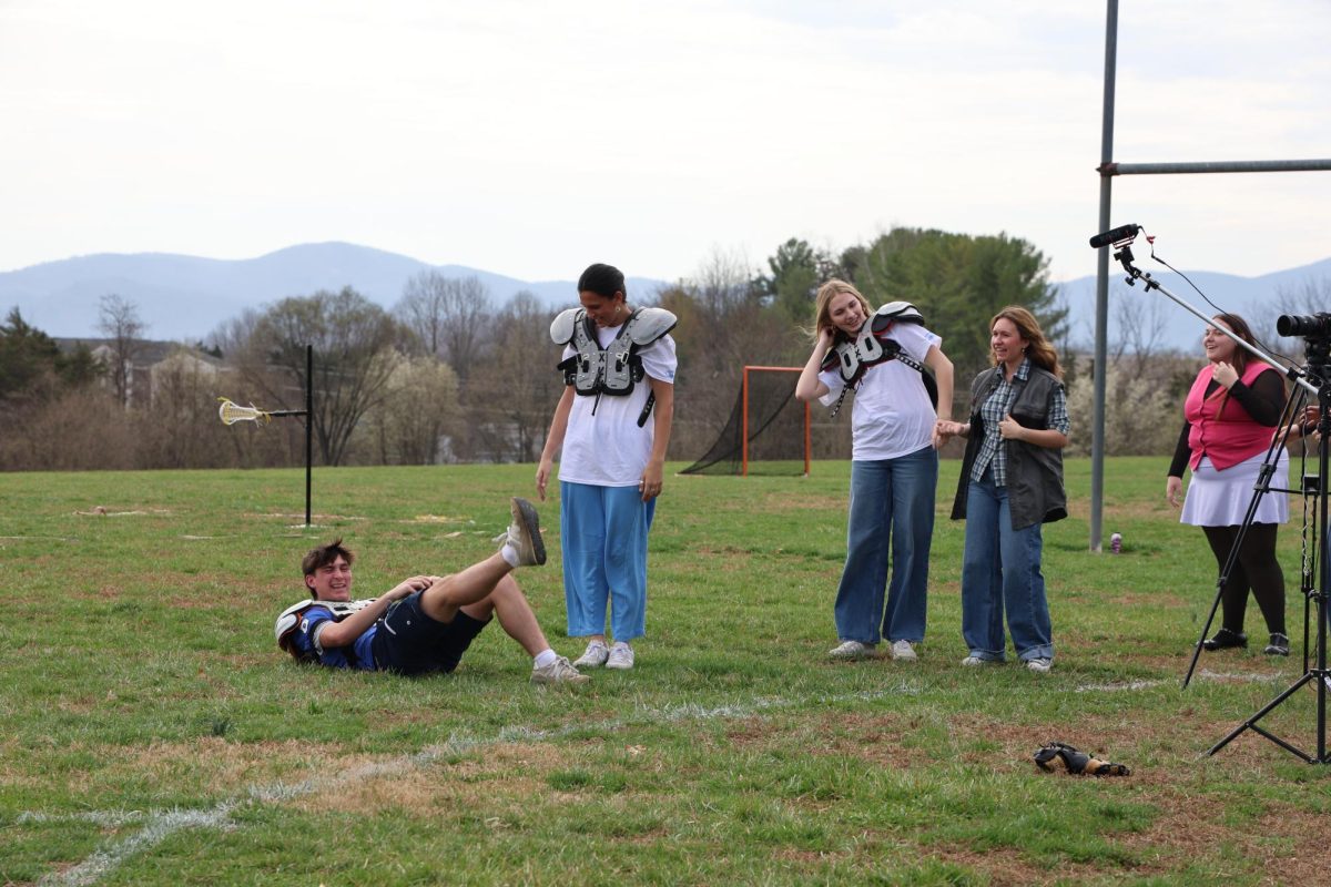 Actors goof around while junior Pat Looney takes a fall during filming. 